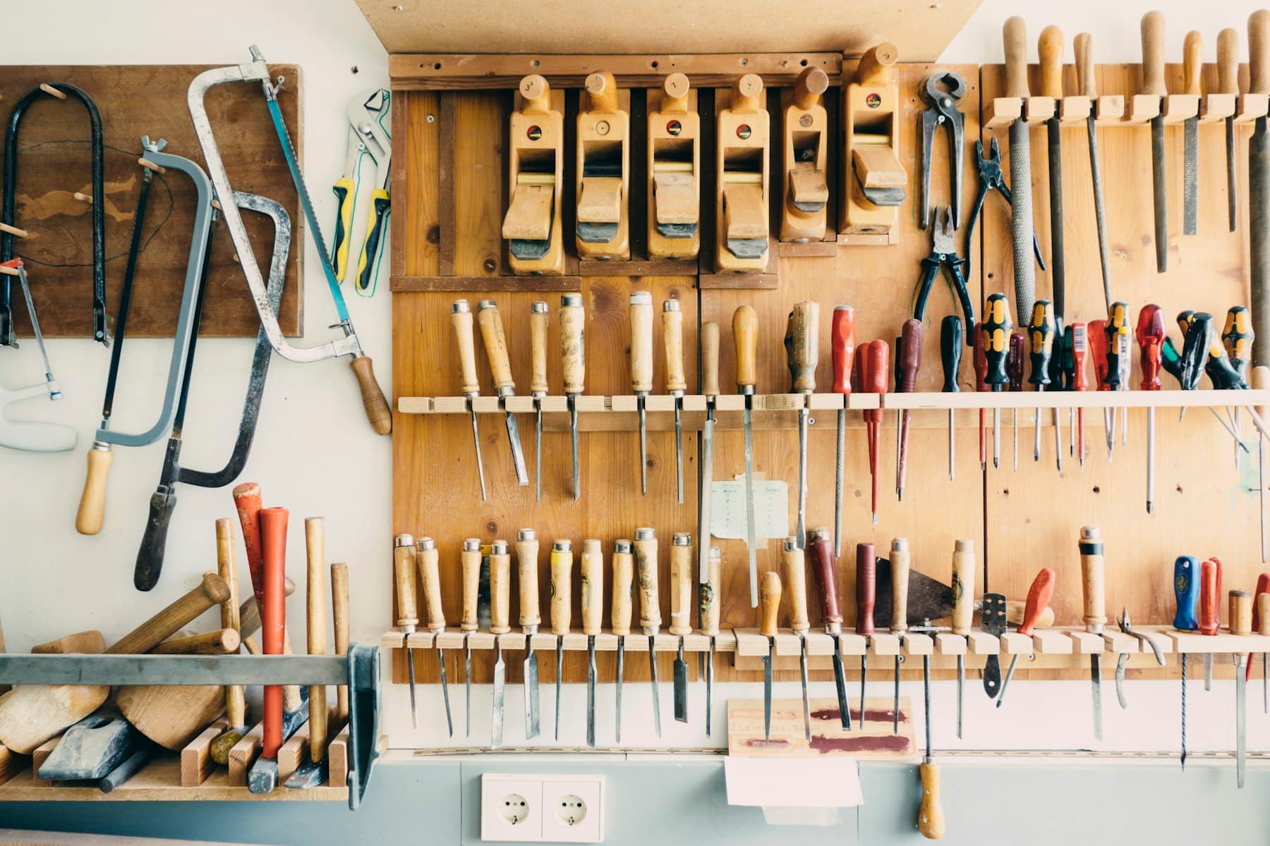 Organized hand tools on a workshop wall
